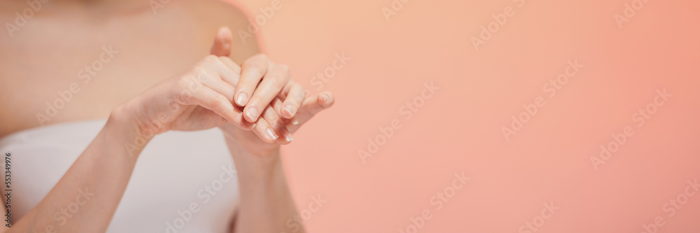 Woman in white t-shirt using hand skin care product