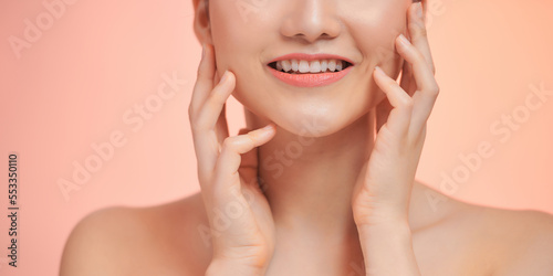 Portrait of attractive Vietnamese woman touching her face: beauty concept