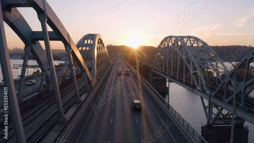 Aerial view car traffic on the bridge highway road. Evening sunset light reflecting on the road. photo