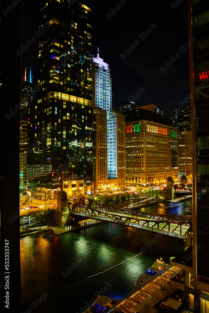 Night life on Chicago ship canals with bridge and skyscrapers