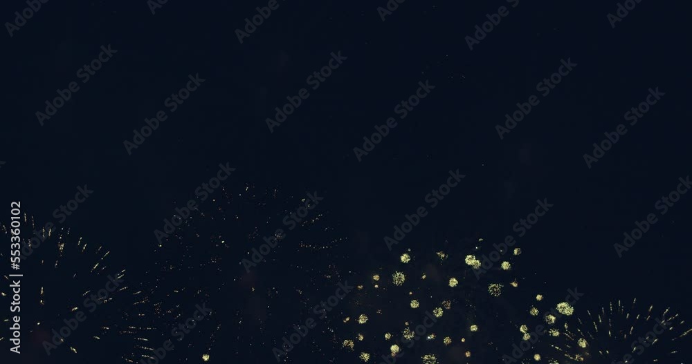 New year's eve fireworks display celebration loop seamless of real fireworks background with abstract multicolor big shining glowing fireworks show with bokeh lights in the night sky. 4KDCI