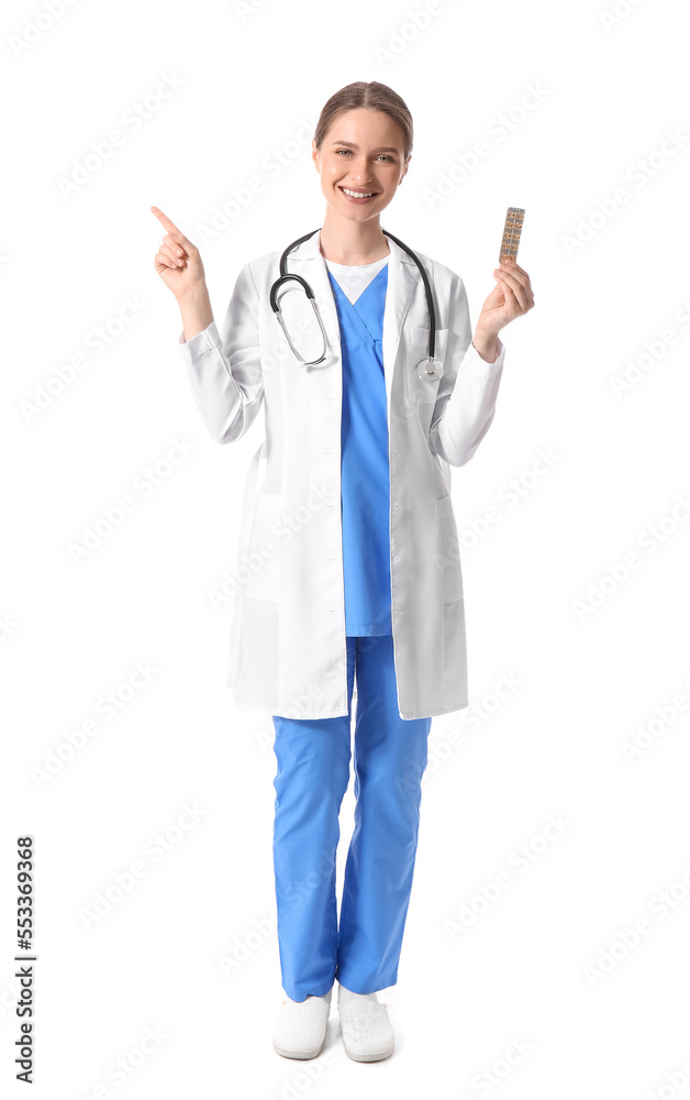 Female doctor with vitamins pointing at something on white background Female doctor with vitamins pointing at something on white background