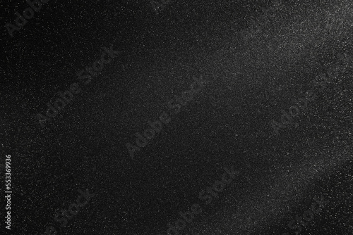 Black texture with white speckles as background
