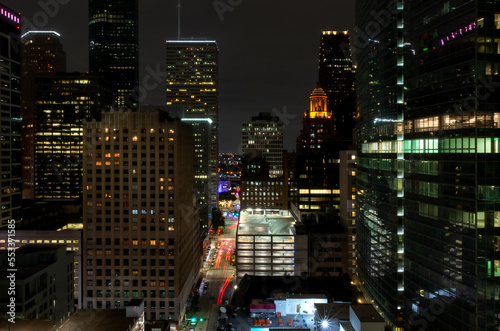 Cityscape Image of Downtown Houston at Night Showcasing City Nightlife with many Modern and Old Buildings in Sight