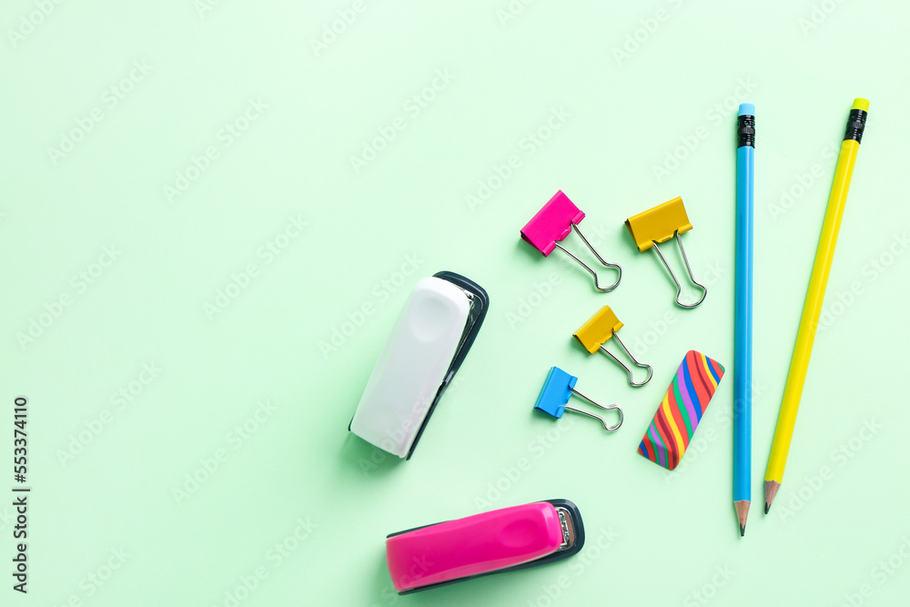 Staplers, paper clips, eraser and pencils on color background Staplers, paper clips, eraser and pencils on color background