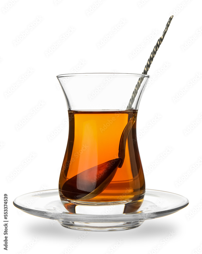 Glass of Turkish tea with spoon on white background
