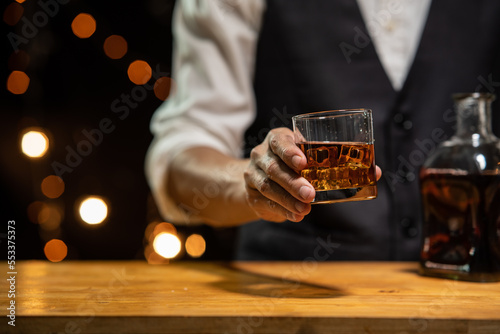 Barman pouring whiskey whiskey glass beautiful night