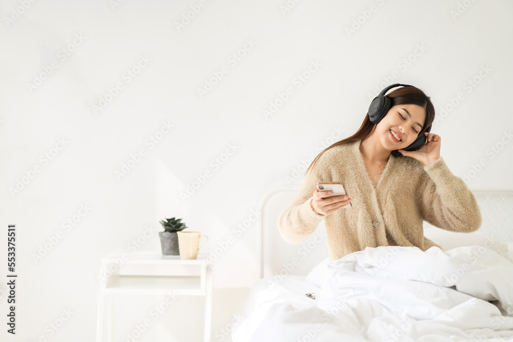 Portrait of smiling cheerful beautiful pretty asian woman clean fresh healthy white skin posing smile in pajamas clothes.Girl felling relax and enjoy time on the bed at home.asia beauty Portrait of smiling cheerful beautiful pretty asian woman clean fresh healthy white skin posing smile in pajamas clothes.Girl felling relax and enjoy time on the bed at home.asia beauty