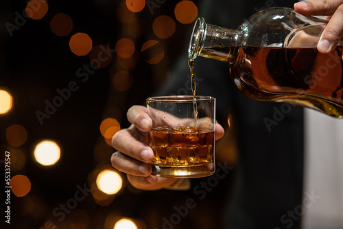 Barman pouring whiskey whiskey glass beautiful night