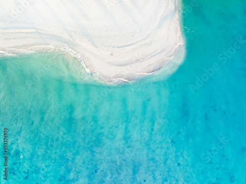 The ecology with blue waves water on the sand bank beach background. Above view