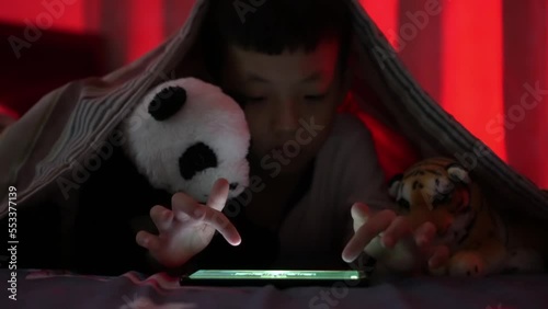 Focus the hand of kid play game in the blanket