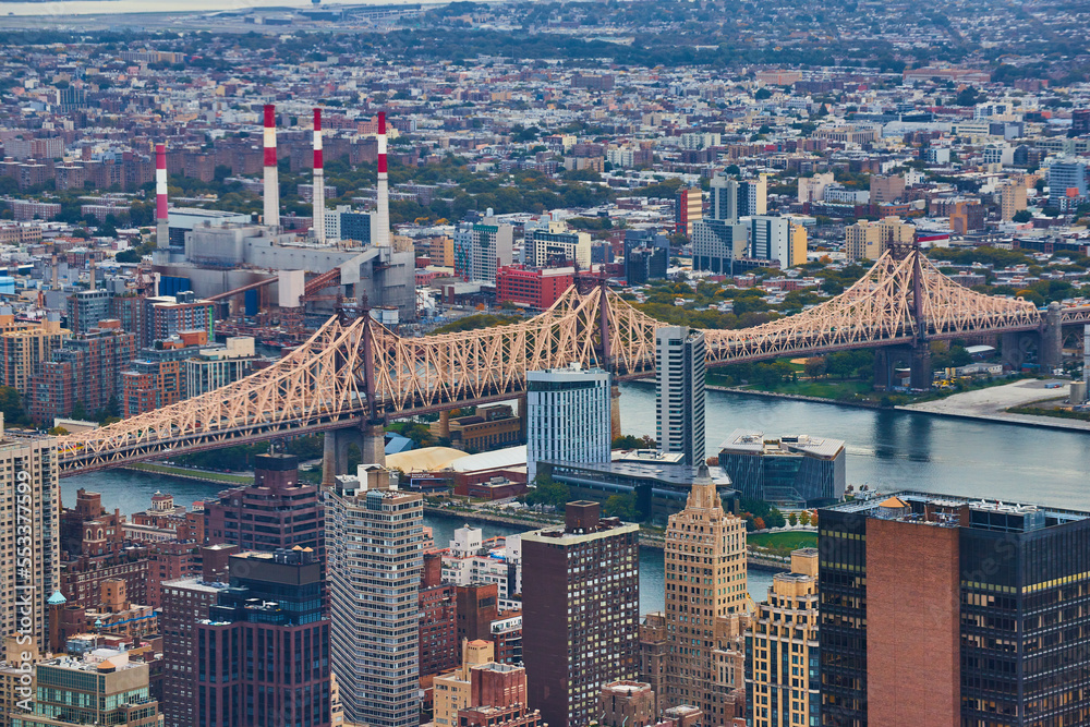 Bridge crossing over into New York City from above in detail with industrial buildings
