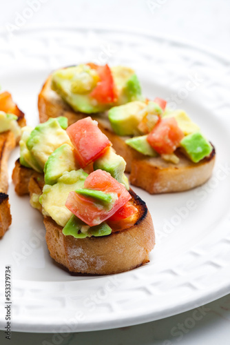 bruschetta with chopped tomatoes and avocado
