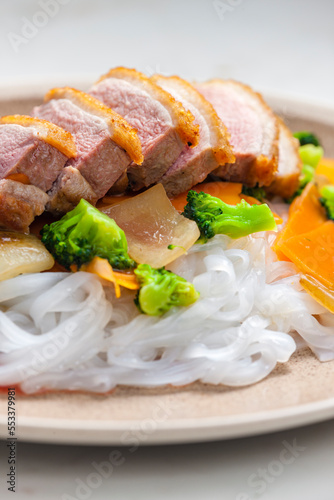 baked duck breast with vegetables and rice noodles