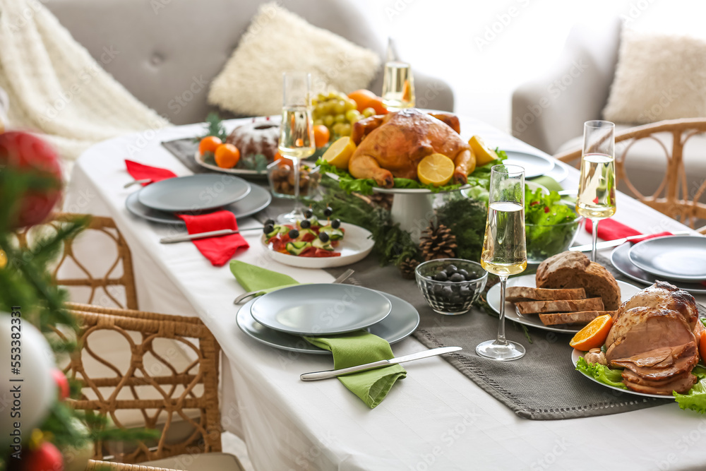 Christmas table setting with tasty ham and bread in dining room, closeup