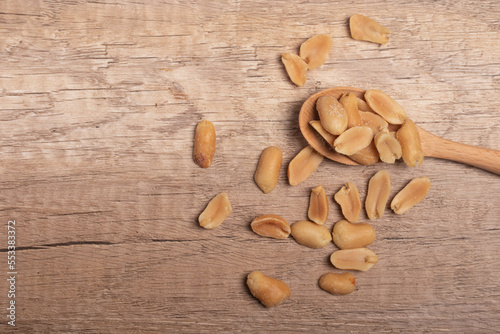 salted roasted peanuts on wooden background