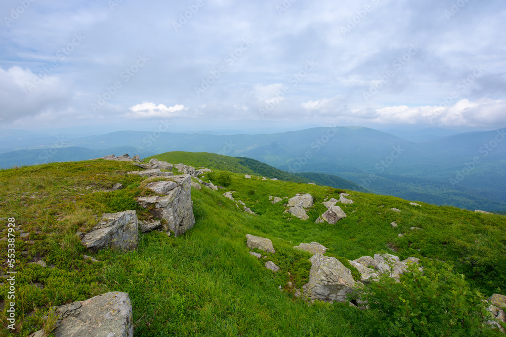 carpathian mountain landscape on a rainy day. stones and boulders on the grassy hills and meadows. unpredictable weather forecast concept