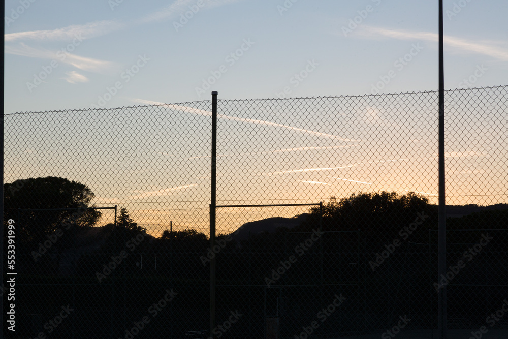 Fototapeta premium landscape at sunset with sports facilities and full moon in the background in clear sky