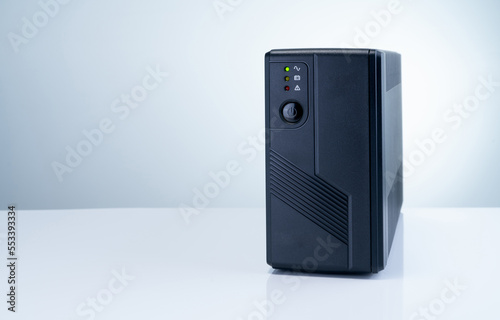 Uninterruptible power supply on white background. Backup Power UPS with battery. UPS with stabilizer for home PC. UPS inverter. Equipment for computer system at office for security. Power protection.
