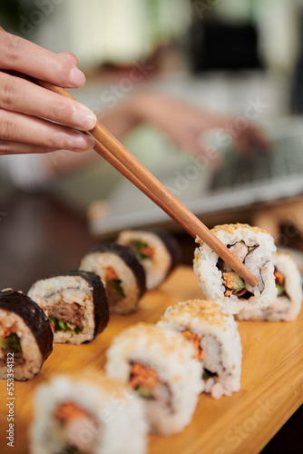 Woman Eating Delicious Homemade Sushi