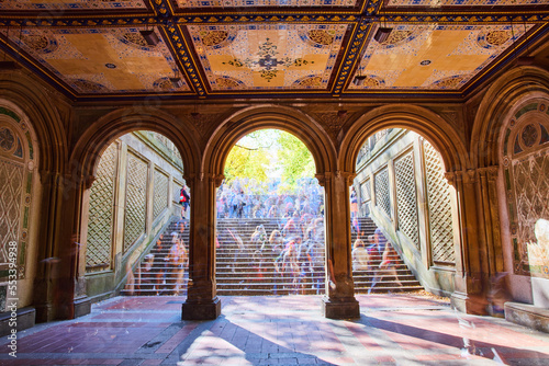Crowded Central Park staircase through limestone arches with murals on ceiling and faded people