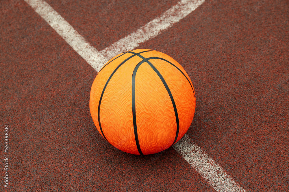 One basketball ball on playground rubber coating One basketball ball on playground rubber coating
