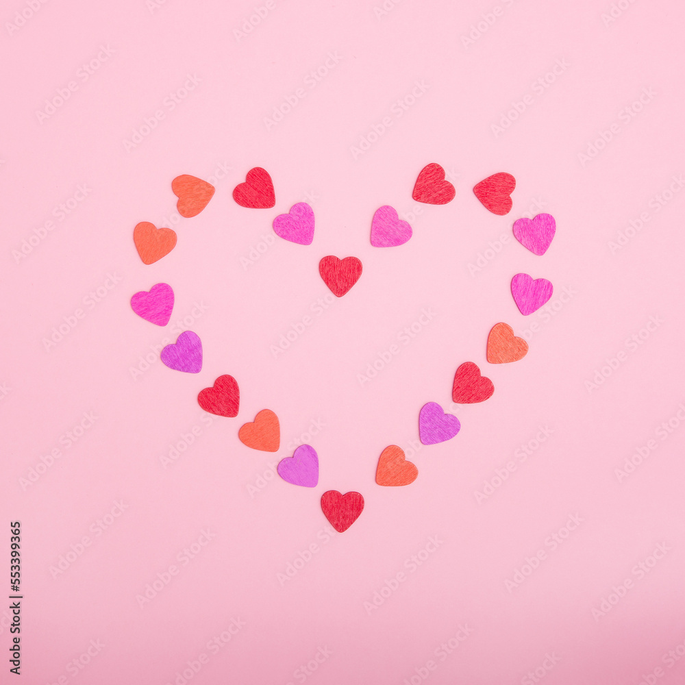 Heartshaped frame made of small hearts on a pink background. The concept of Valentine's day, love, dating and wedding. Symbol of a romantic gift or marriage proposal. Copy space, minimalism, square ph