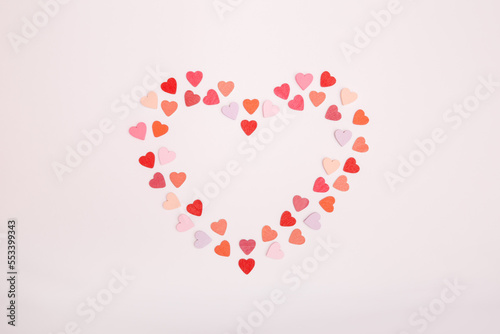 Heart-shaped frame made of small hearts on a gray background. The concept of Valentine s day  love  dating and wedding. Symbol of a romantic gift or marriage proposal. Copy space  minimalism.