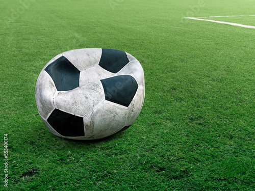 old deflated soccer ball on soccer field