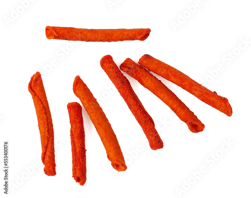 Pile of spicy corn chips isolated on white background. Hot rolled chips.