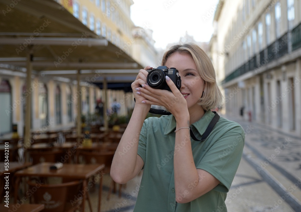 Smiling woman taking photo. Female model with camera taking photos and travelling. Portrait, travelling concept