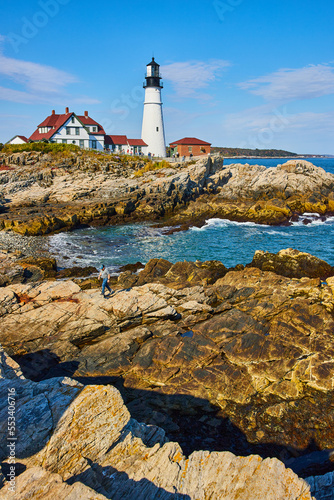 Portland Head Light lighthouse on rocky coasts in Maine with ocean waves
