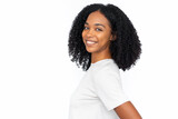 Happy African American woman smiling. Side portrait of cheerful young female model with dark curly hair in white T-shirt looking at camera with confident look. Success, happiness concept