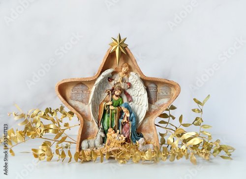 Traditional christmas native scene and decorations on abstract light background. Star of Bethlehem, symbol of Christmas, Advent holiday. festive winter season photo