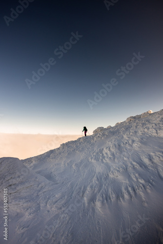 climbers climb to the top of the mountain in winter