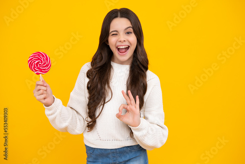 Excited teenager girl with caramel candies on sticks, sweet sugar addiction. Child with lollipops.