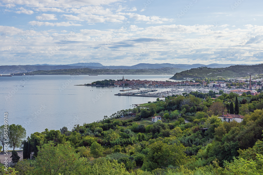 Overview of Izola and its coastline with ships awaiting to enter Koper harbor