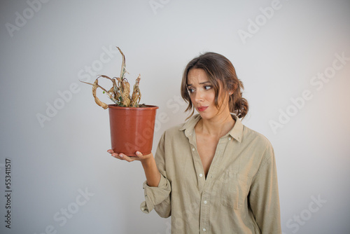 Dead Plant Woman Holding Pot with a Dead Dehydrated Plant with Brown Leaves Feeling Frustrated