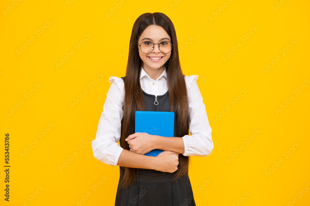 Teen girl pupil hold books, notebooks, isolated on yellow background, copy space. Back to school, teenage lifestyle, education and knowledge. Happy girl face, positive and smiling emotions. Teen girl pupil hold books, notebooks, isolated on yellow background, copy space. Back to school, teenage lifestyle, education and knowledge. Happy girl face, positive and smiling emotions.