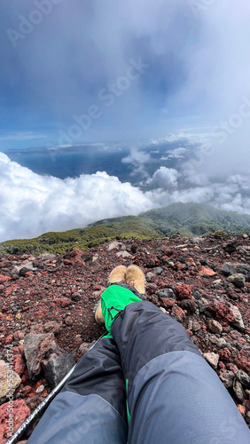 Panorama of flowing fog waves on mountain tropical rainforest, image over the clouds Amazing nature background with clouds and mountain peaks in Purbalingga. photo