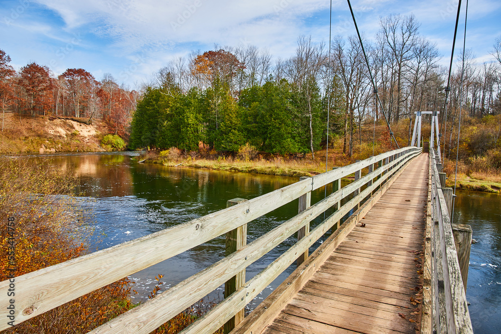 Manistee River Trail suspension bridge in late fall over river Manistee River Trail suspension bridge in late fall over river