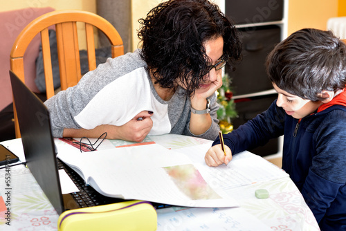 photograph of a woman doing homework with her child. selective focus