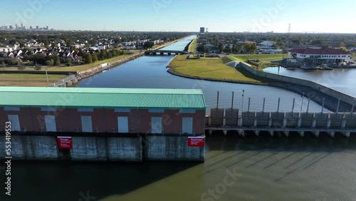 Water pumping station and levee system to protect New Orleans from hurricane flooding. Rising aerial reveal at 17th St. Canal.