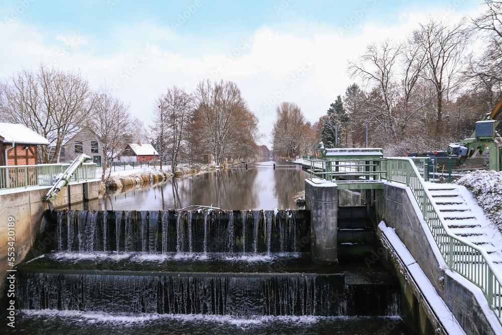 View of the Dahme flood channel with weir in winter, Märkisch Buchholz, Federal state Brandenburg, Germany View of the Dahme flood channel with weir in winter, Märkisch Buchholz, Federal state Brandenburg, Germany