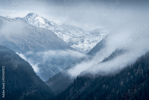 Dreiherrnspitze  Picco dei Tre Signori mountain in the back with dramatic mountain slopes on a cloudy and rainy day in Austrian-Italian Alps. Snow and glaciers n the top of Alpine mountain.