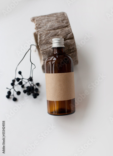 One cosmetic dark amber glass bottle with kraft paper label, minimalism brand packaging mock up