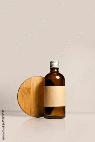 One cosmetic dark amber glass bottle with kraft paper label, minimalism brand packaging mock up