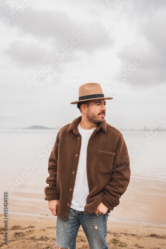 Caucasian man wearing a hat in a lake in winter