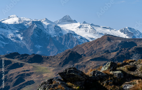 Olperer mountain covered in snow and Tuxer Ferner glacier on a beautiful sunny day of autumn with Hoarbergkarspitze in front. Dramatic alpine peaks under blue sky. Glacier ski resort in Austrian Alps photo