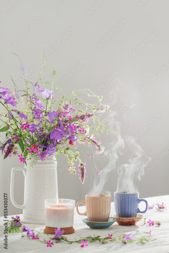 herbal tea with summer wild flowers on white wooden table herbal tea with summer wild flowers on white wooden table
